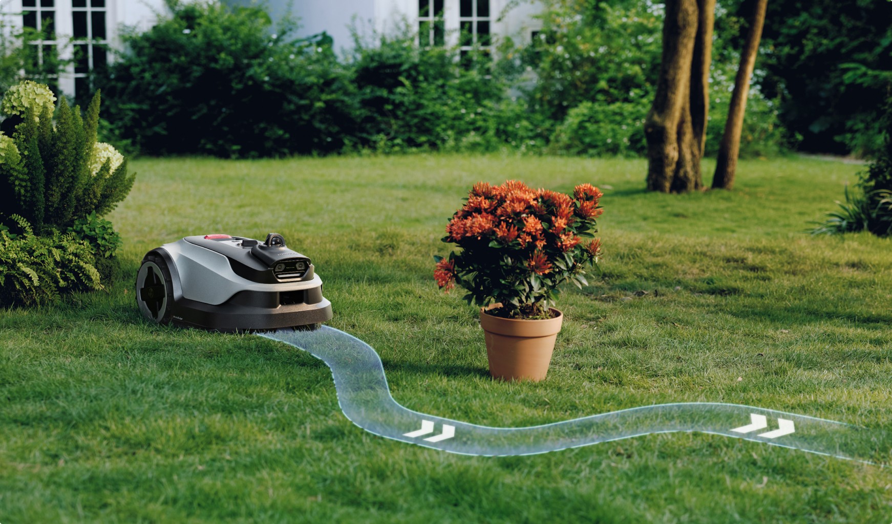 Smart robot mower smoothly steering around a soccer ball on garden grass